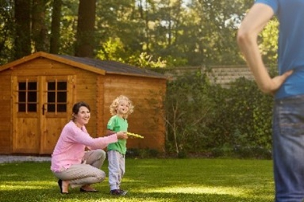 Family in yard with shed